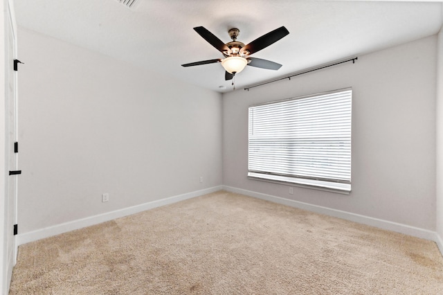 carpeted empty room featuring ceiling fan