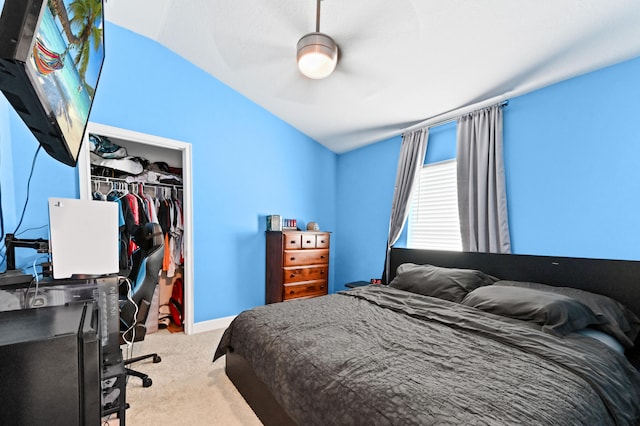 bedroom featuring ceiling fan, lofted ceiling, light carpet, and a closet