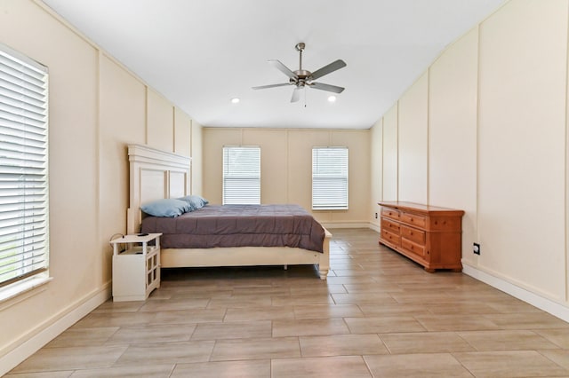 bedroom with light hardwood / wood-style floors and ceiling fan