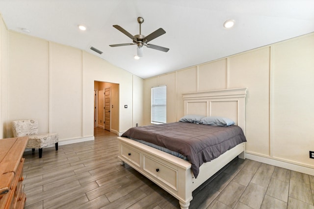 bedroom featuring ceiling fan, wood-type flooring, and lofted ceiling