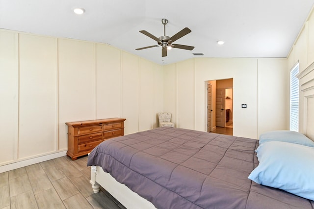 bedroom featuring ceiling fan, light wood-type flooring, and vaulted ceiling