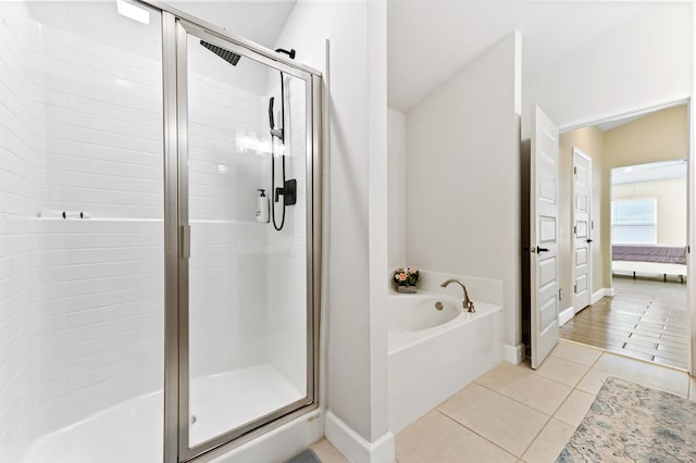 bathroom with tile patterned floors and independent shower and bath