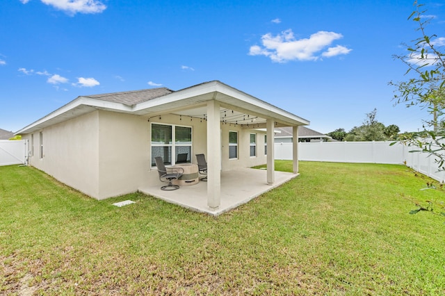 back of property featuring a yard and a patio area