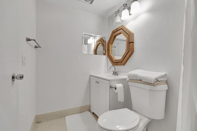 bathroom with vanity, tile patterned flooring, and toilet