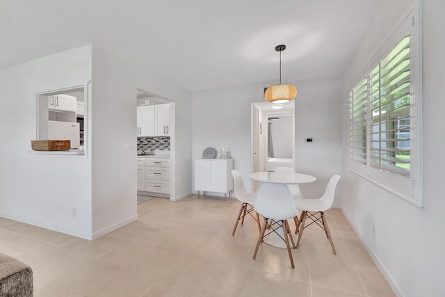 740 Horizons W Unit 105, Boynton Beach, FL 33435 - dining space with light tile patterned floors and baseboards