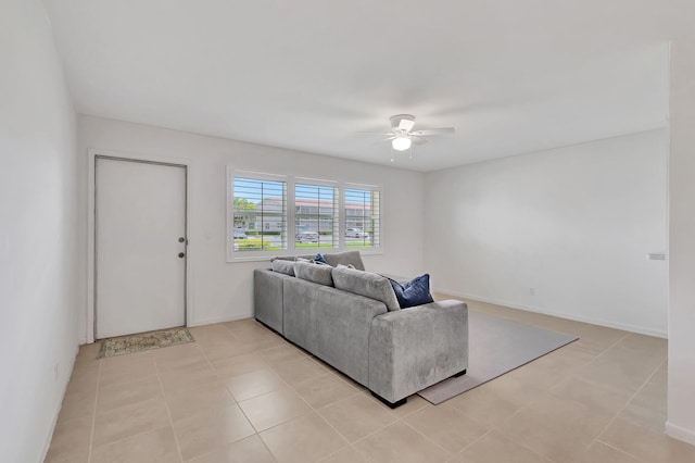 living room with ceiling fan and light tile patterned floors