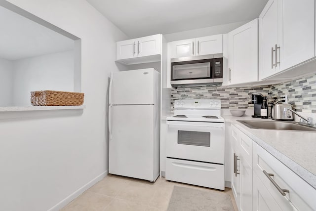 740 Horizons W Unit 105, Boynton Beach, FL 33435 - kitchen featuring white appliances, white cabinets, light countertops, backsplash, and a sink