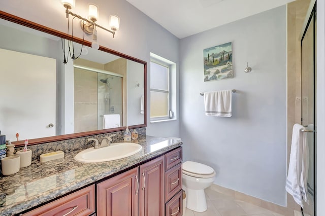 bathroom featuring tile patterned flooring, vanity, toilet, and walk in shower