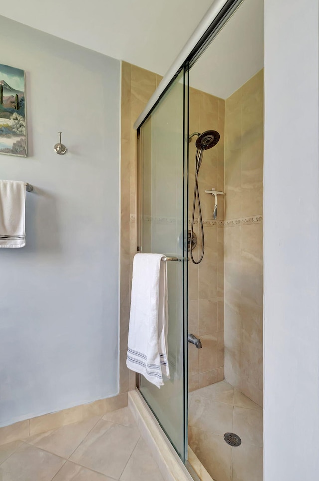 bathroom featuring tile patterned floors and an enclosed shower