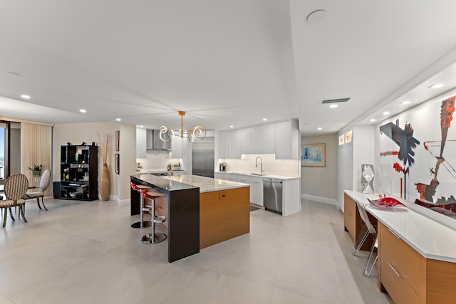 kitchen with white cabinetry, pendant lighting, a center island, dishwasher, and light tile patterned floors