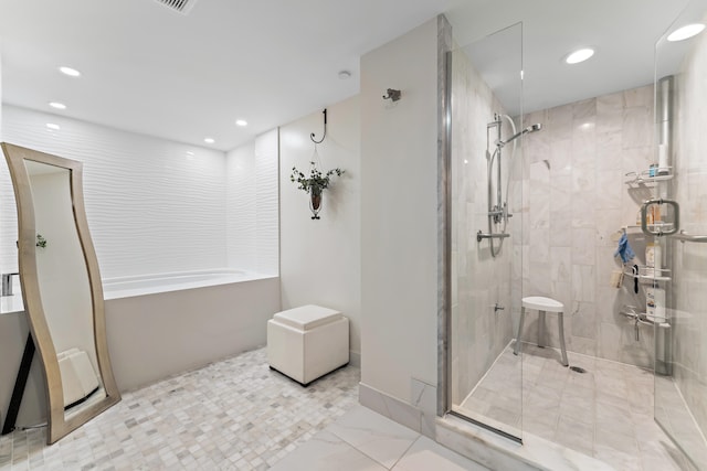 bathroom with shower with separate bathtub and tile patterned floors