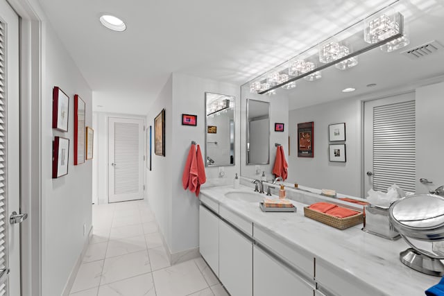 bathroom featuring tile patterned flooring and vanity