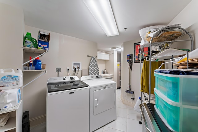 washroom featuring light tile patterned flooring and washer and dryer