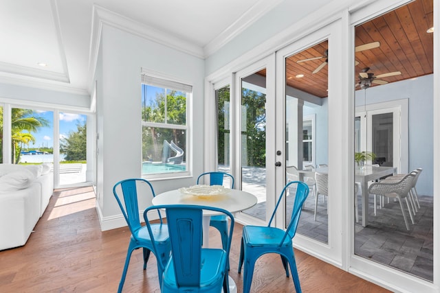 sunroom / solarium with ceiling fan, french doors, and wooden ceiling