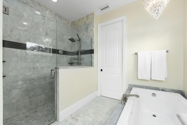 bathroom featuring a notable chandelier and plus walk in shower