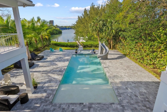 view of swimming pool featuring a water view and a water slide