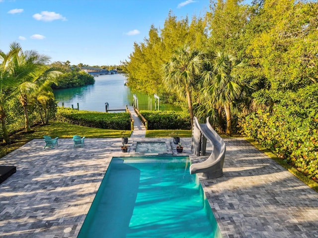 view of swimming pool with a water view, a patio area, and a water slide