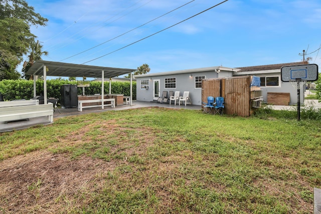 back of house featuring a yard and a patio