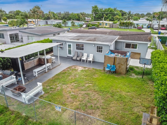 rear view of property featuring a lawn