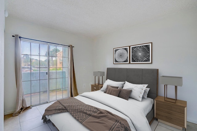 tiled bedroom with access to exterior and a textured ceiling