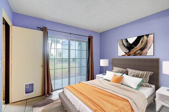 empty room featuring a healthy amount of sunlight, light tile patterned floors, and a textured ceiling