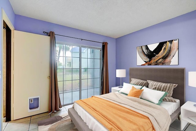 tiled bedroom featuring access to exterior and a textured ceiling