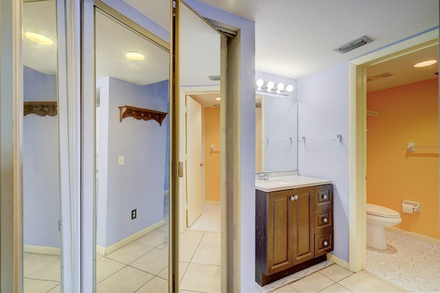 washroom with light tile patterned floors and stacked washing maching and dryer