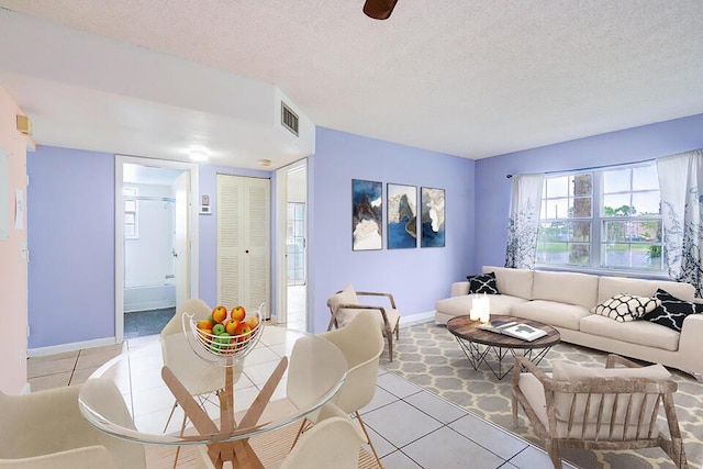 tiled living room featuring a textured ceiling