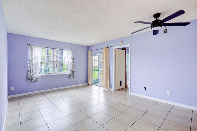 tiled empty room with a textured ceiling and ceiling fan