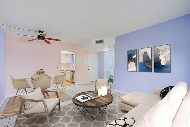 tiled living room with ceiling fan