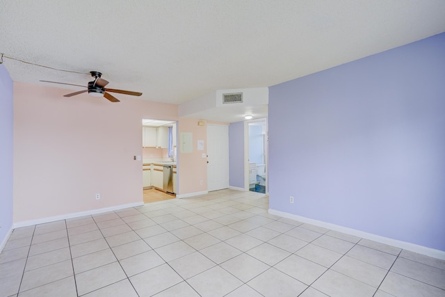 tiled spare room with ceiling fan and a textured ceiling