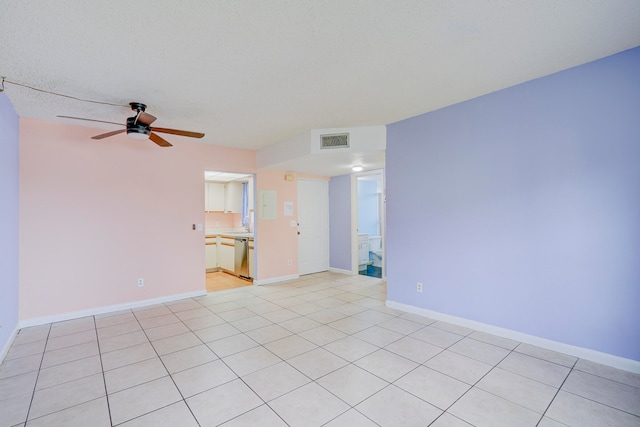 empty room with light tile patterned floors, a textured ceiling, and ceiling fan