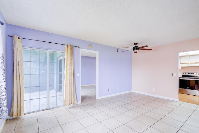 unfurnished living room featuring ceiling fan, light tile patterned floors, and a textured ceiling