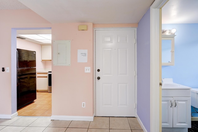 foyer with light tile patterned floors and electric panel