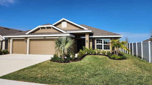 view of front facade featuring a garage and a front yard