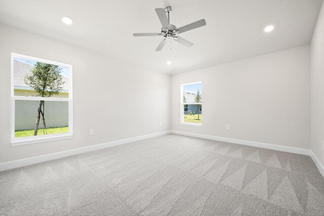 unfurnished room with light carpet and ceiling fan