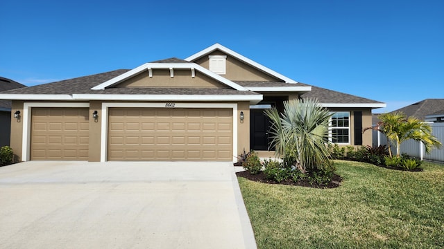 view of front facade with a front yard and a garage