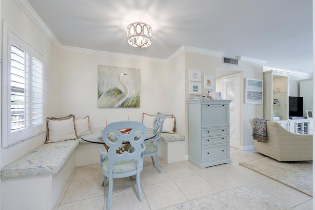 dining room with light tile patterned flooring, crown molding, and breakfast area