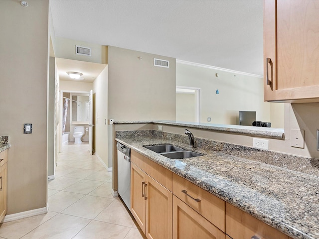 kitchen with sink, stainless steel dishwasher, stone countertops, and light tile patterned floors