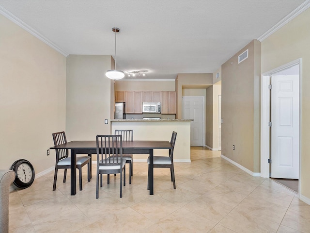 tiled dining area featuring ornamental molding