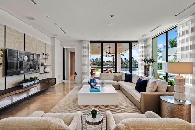 living room featuring expansive windows and a water view