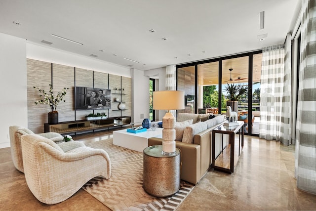 living room featuring visible vents and expansive windows