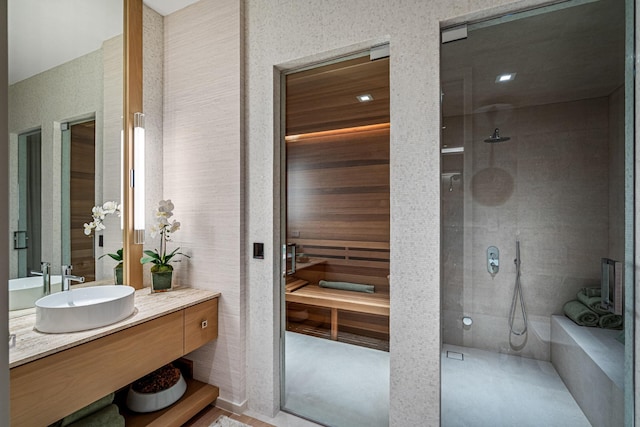 full bathroom featuring vanity and a tile shower