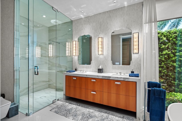 full bathroom with a marble finish shower, double vanity, a freestanding bath, a sink, and marble finish floor