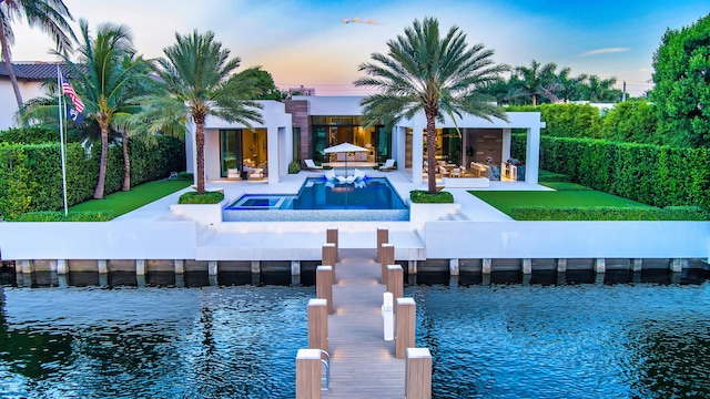 190 NE 5th Ave, Boca Raton, FL 33432 - back of property at dusk featuring a water view, a patio area, an outdoor pool, and outdoor lounge area