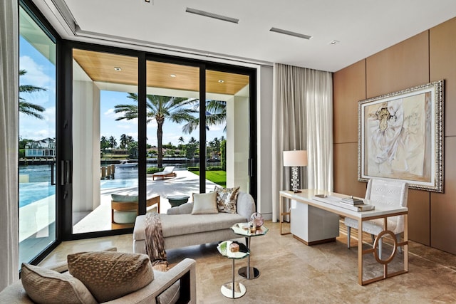 living area featuring a water view and floor to ceiling windows