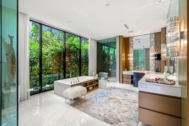 bathroom featuring a freestanding tub, expansive windows, a stall shower, and vanity