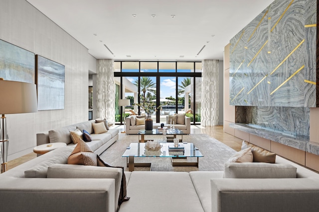 sunken living room featuring floor to ceiling windows