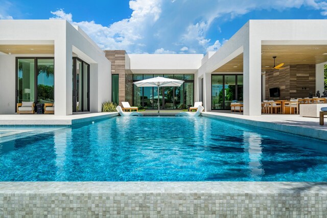 view of pool featuring a patio area and ceiling fan