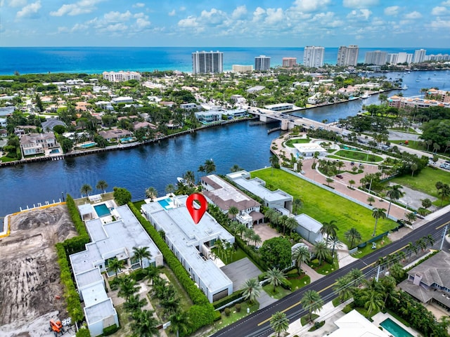 birds eye view of property with a view of city and a water view